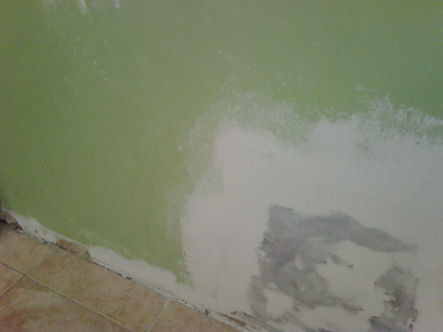 Fresh drywall patch coated and drying on an interior wall